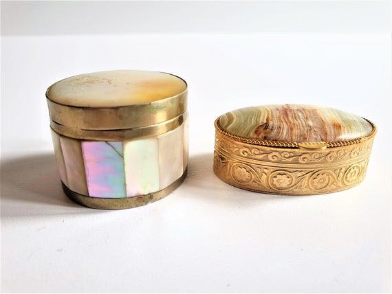 A small group of modern silver pill boxes and other various pill